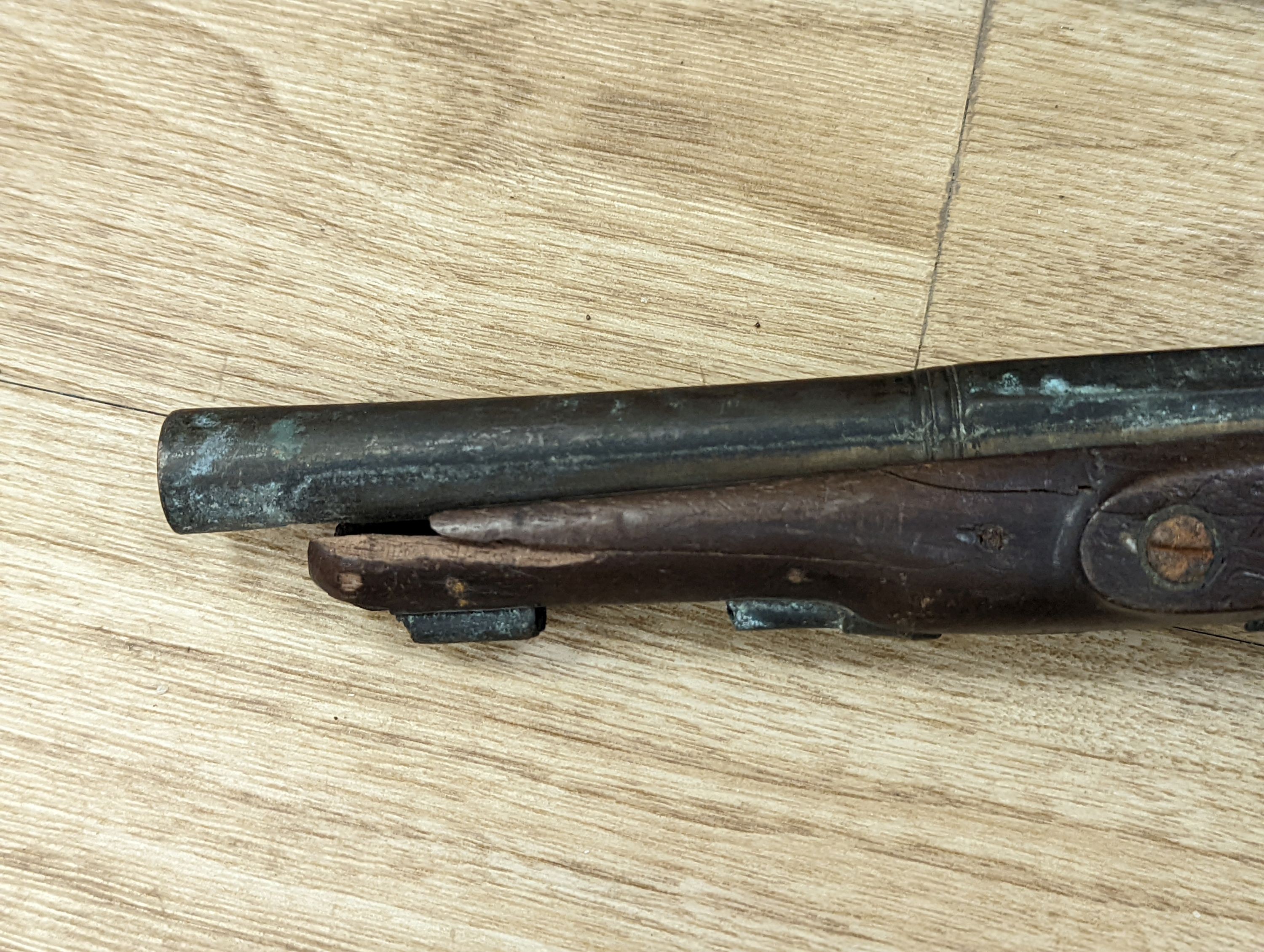 Two 19th century flintlock pistols and a pocket pistol, largest 40 cms long.